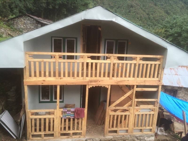 A new two-storey house with a timber balcony, built by trainees in Lukla